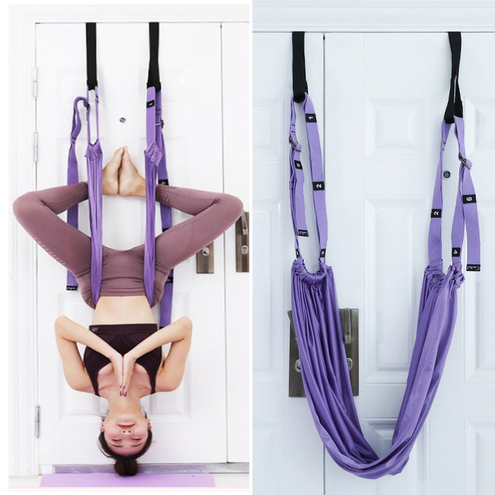 Yoga stretch strap hanging from a door