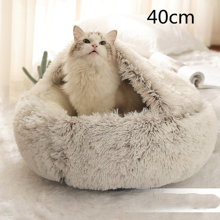 Cat curled in round plush hooded pet bed
