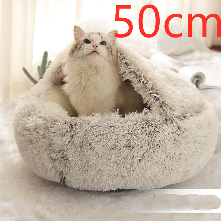 Cat curled in round plush hooded pet bed