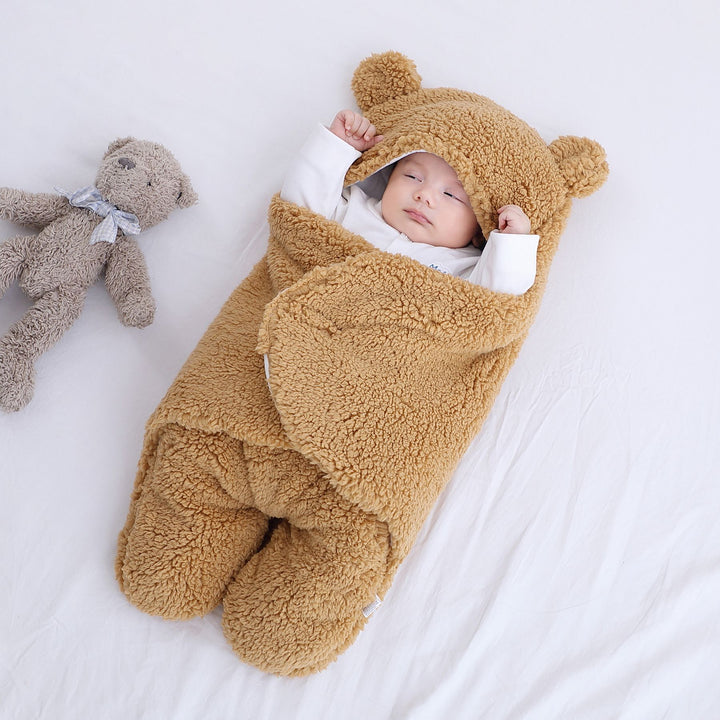 Baby in plush bear-ear hooded wrap