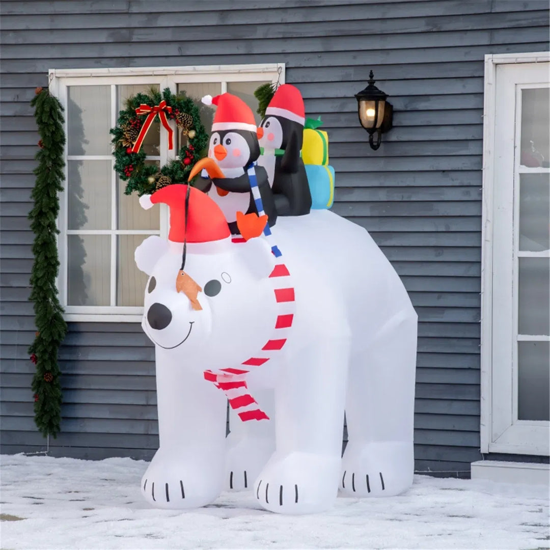 Inflatable polar bear with two penguins
