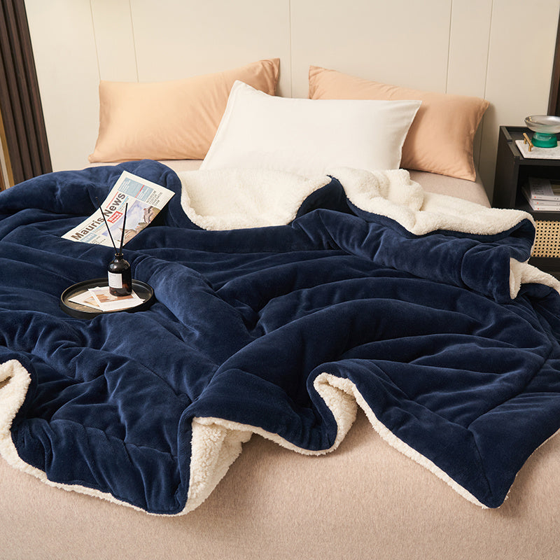 Reversible sherpa throw on a bed