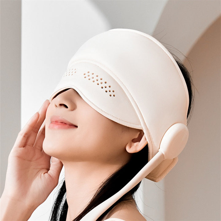 Person wearing hooded head massager wrap