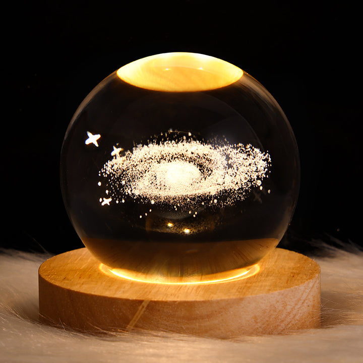 Glowing crystal ball lamp on wood base