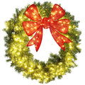 Large lit Christmas wreath with red bow