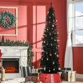 Slim black pencil Christmas tree in corner
