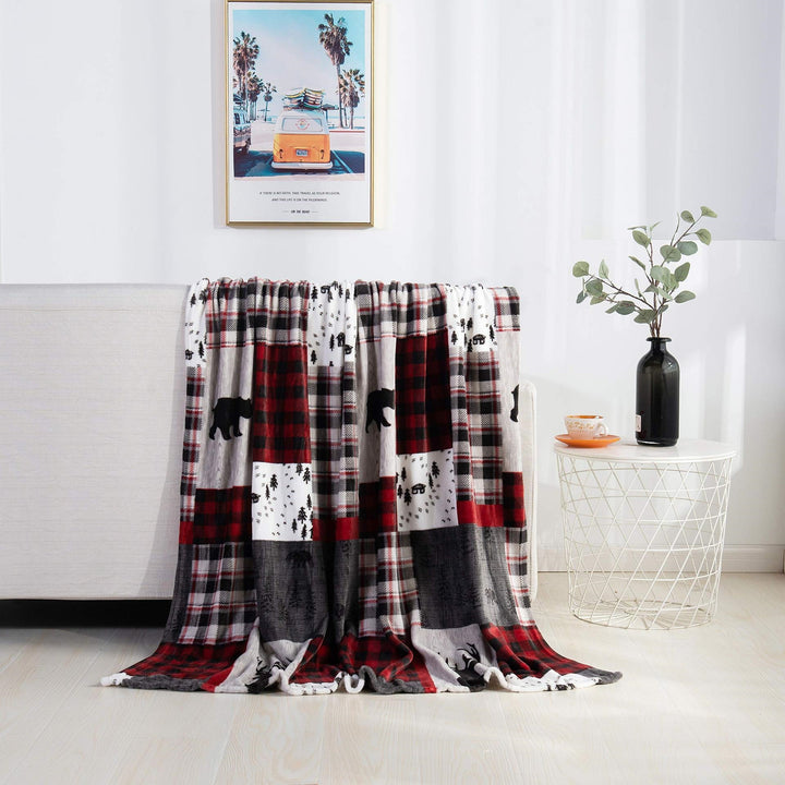 Christmas fleece throw blanket on a sofa
