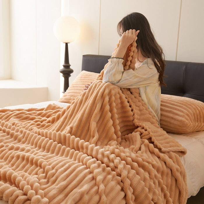 Dusty rose ribbed faux fur blanket on bed