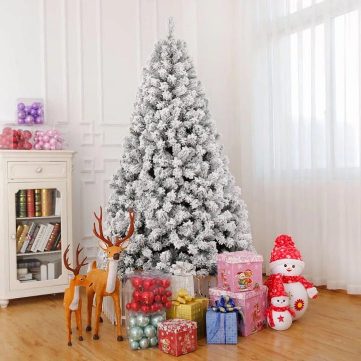 Snow-flocked pre-lit tree glowing white