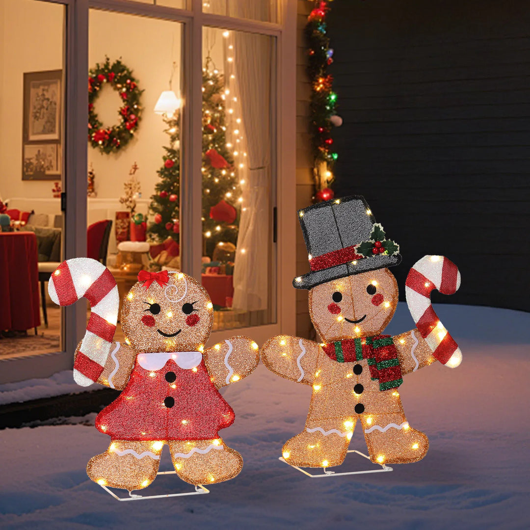 Two light-up gingerbread figures with candy canes