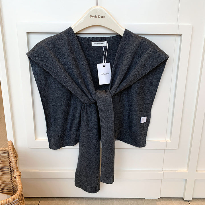 Woman wearing knitted tie front shoulder wrap