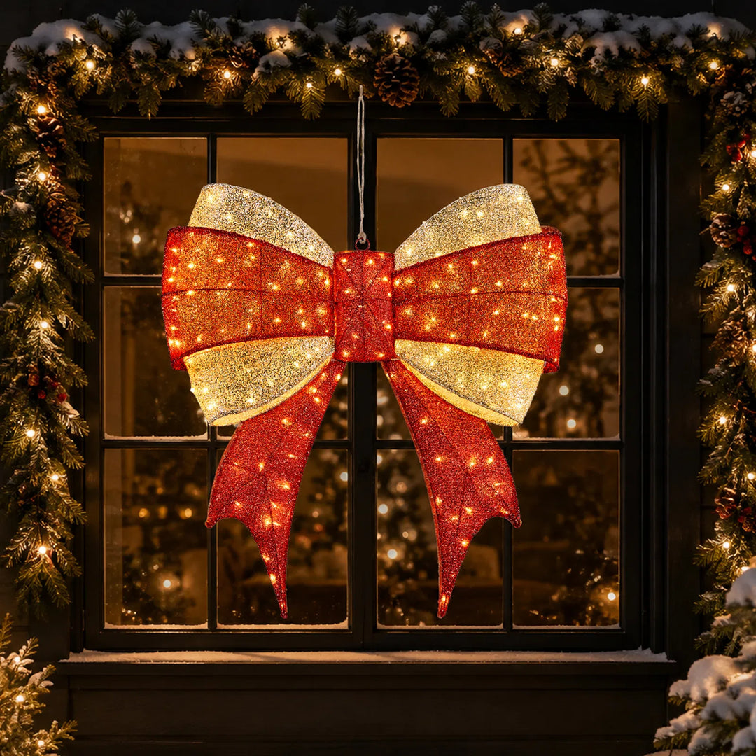 Large lit red and gold Christmas bow