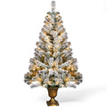 Small flocked tree in a decorative pot