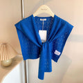 Woman wearing knitted tie front shoulder wrap