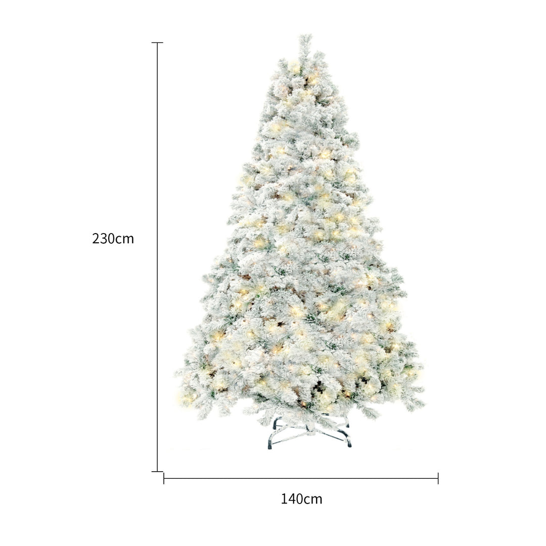 Snow-flocked Christmas tree with warm-white lights