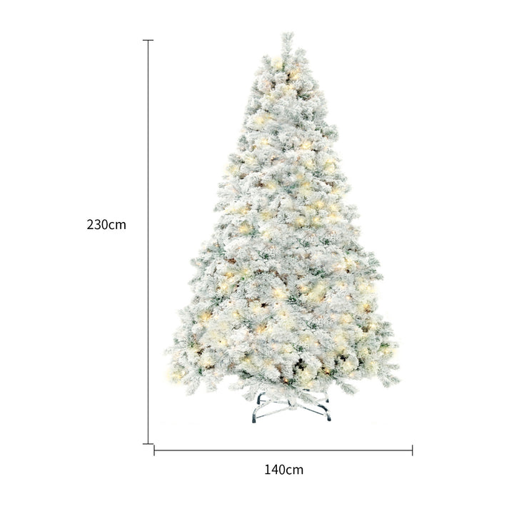 Snow-flocked Christmas tree with warm-white lights