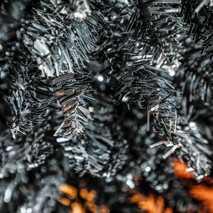 Black pencil Christmas tree with warm lights