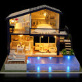 Finished miniature dollhouse with lights on