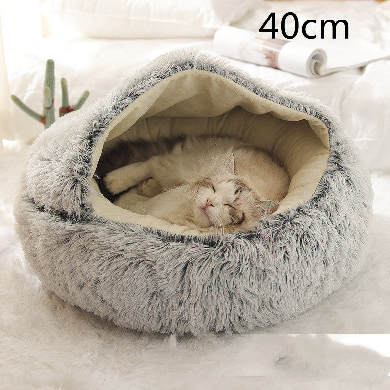 Cat curled in round plush hooded pet bed