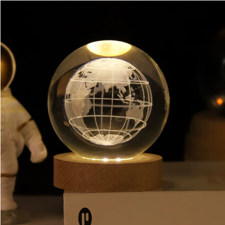 Glowing crystal ball lamp on wood base