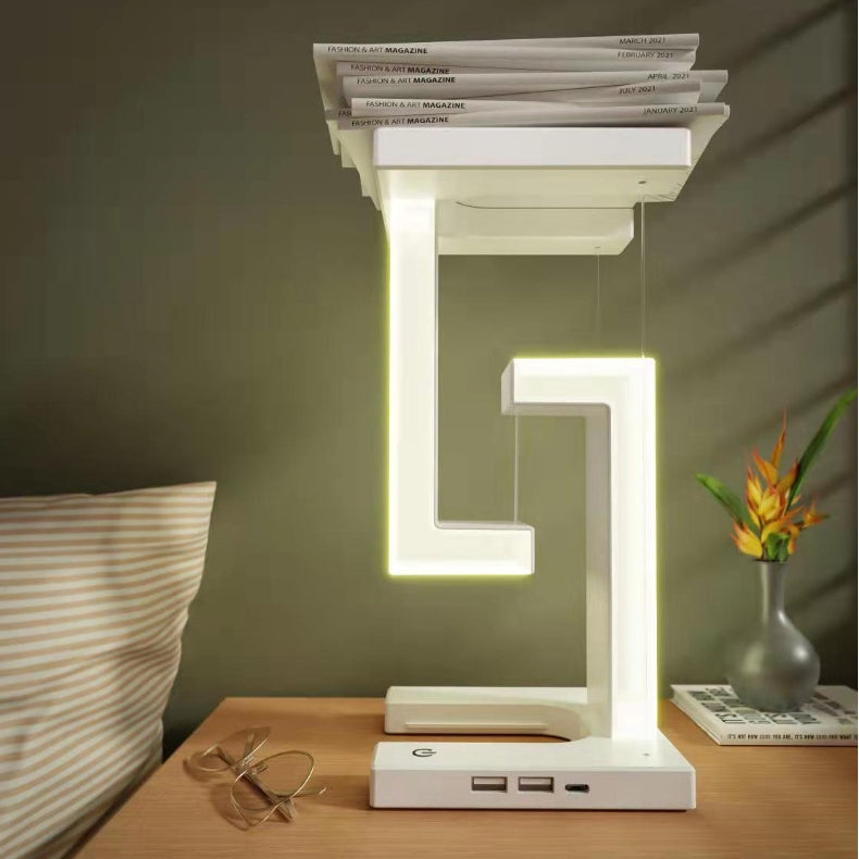 Floating balance lamp with phone on charging base