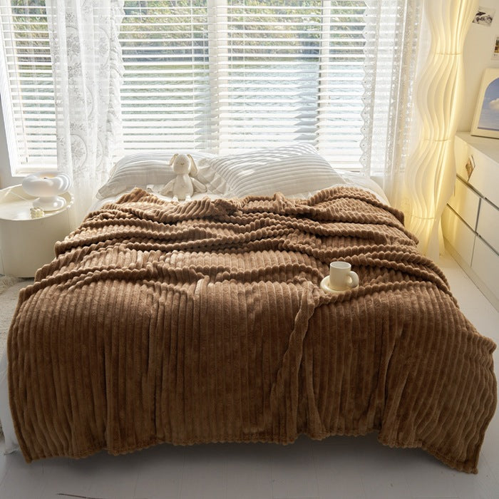 Dusty rose ribbed faux fur blanket on bed