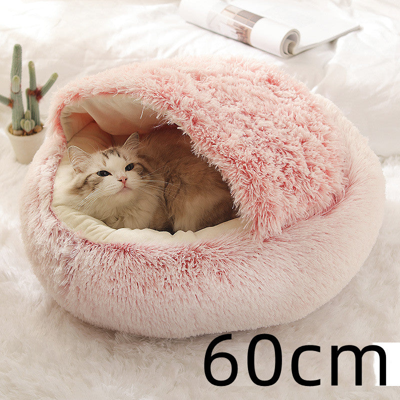 Cat curled in round plush hooded pet bed