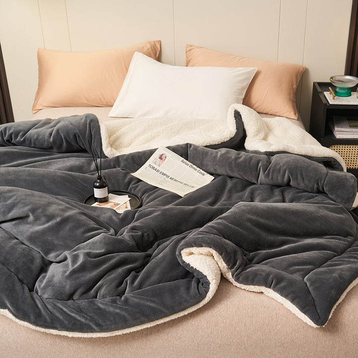 Reversible sherpa throw on a bed