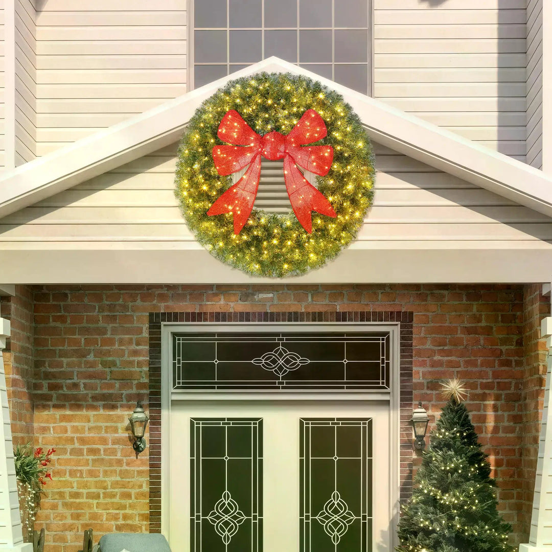 Giant lit Christmas wreath with red bow