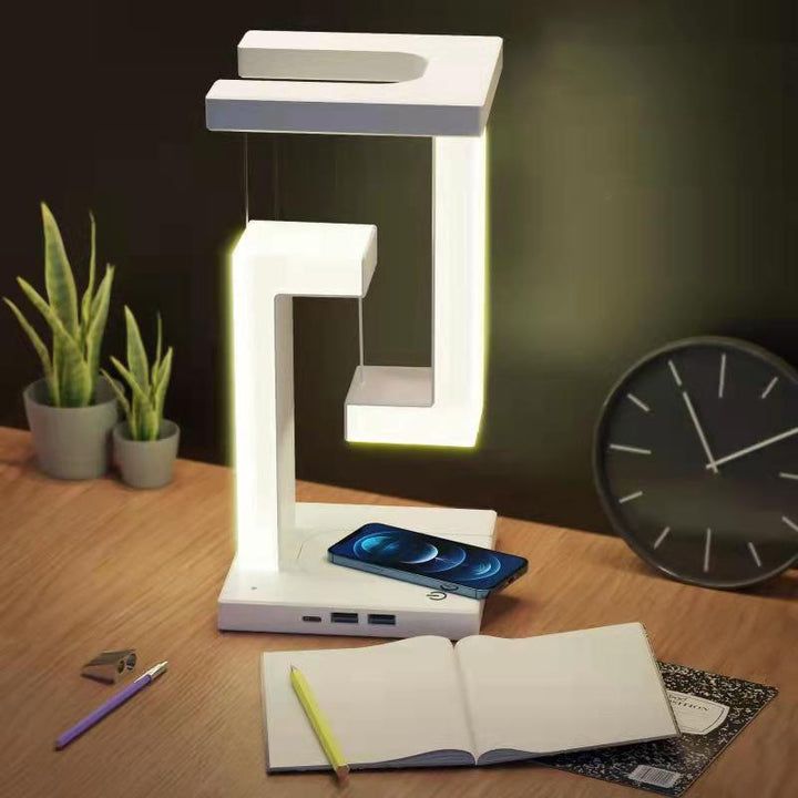 Floating balance lamp with phone on charging base